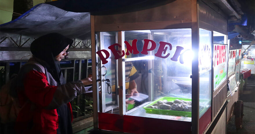 Picture 1: A project representative interview with fish cake seller Mr Afif who usually use candles to sell his products if there is a power outage