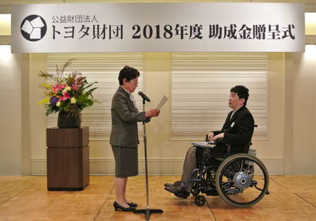 遠山敦子理事長より贈呈書の授与。2018年度国際助成プログラム助成金贈呈式（2018年10月）